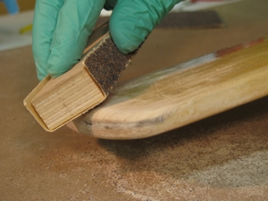 Expose fresh wood on the end of the wooden paddle.