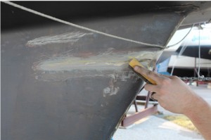 The first step to repairing the keel with G/flex Epoxy was to sand a shallow bevel on each side of the crack to increase surface area for the epoxy. The metal surfaces were sanded with 60-grit to expose bright metal.