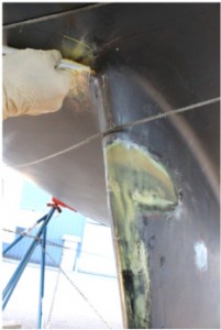 A plastic squeegee worked well to fill all of the keel's low spots with G/flex Epoxy.