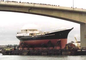 Load Out was carried out on February 3, 2000, after a great deal of preplanning and design work. A 250' x 78' barge was butted up against the quay wall and the 690-ton Tenacious was moved from Jubilee yard onto it. Once safely on the barge and securely fixed, it was towed to Empress Dock.