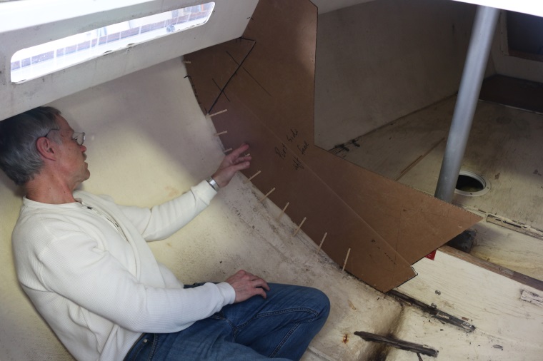 9. Had the bulkhead not come out so cleanly, Tom demonstrates how to make an accurate template by fitting some cardboard loosely then stapling small wooden strips to define the exact shape needed.