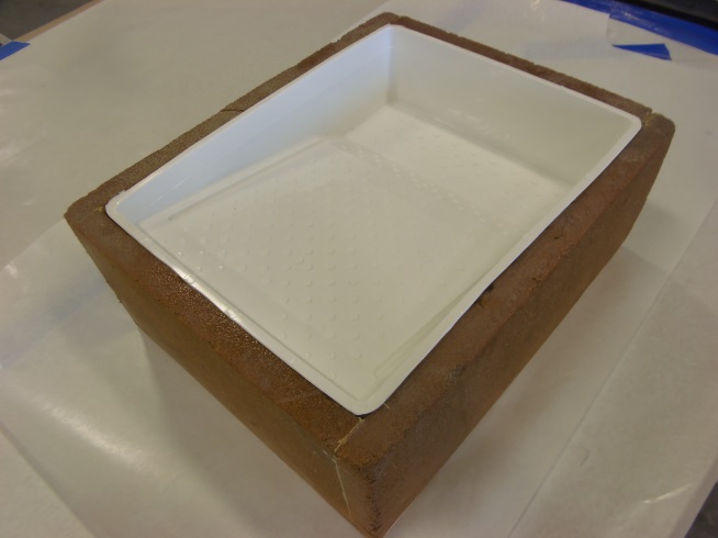 Foam box holding water and a roller pan to help cool epoxy and increase epoxy working time.