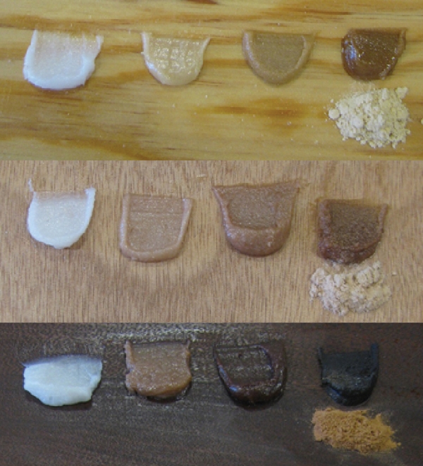 Three different wood types with four dollops of thickened epoxy on each. The first dollop (white on the far left of each) is thickened with all 406 Colloidal Silica filler. The second one is thickened with 406 filler and a bit of wood sanding dust. The third one is thickened with 406 filler then thickened with significantly more wood sanding dust. The fourth one is thickened with wood sanding dust exclusively and is by far the darkest of them all. The dry sanding dust of each wood type is set next to the last thickened epoxy dollop.