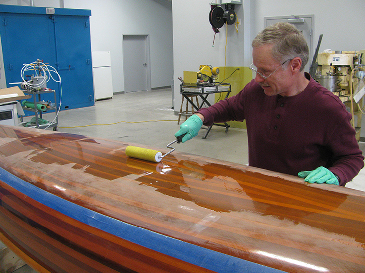 Fill layers applied to the bottom of the wood strip canoe