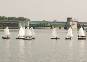 Optimist prams sailing before the Liberty Bridge on the Saginaw River.