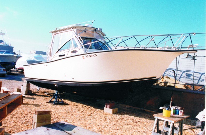 Bottom paint is applied to the exterior after the fairing material is sealed with epoxy.