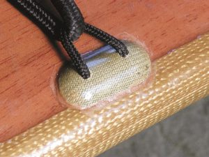 Close up of a soft eye pad mounted to the deck of a Bufflehead. The pad eyes Hugh Horton used on the Bufflehead deck were made wtih Twaron™ an aramid fiber. The soft pad eyes are strong yet not as likely as rigid pad eyes to catch a knuckle or a knee cap.