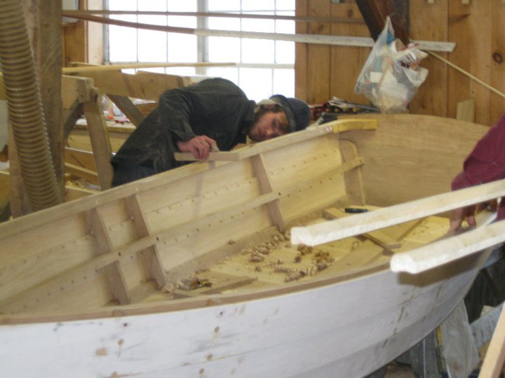 A student a The Apprenticeshop is working hard on a traditional lapstrake dory.