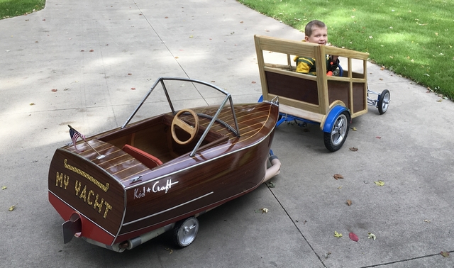 Daniel's grandson taking his new car and boat with trailer for a spin.